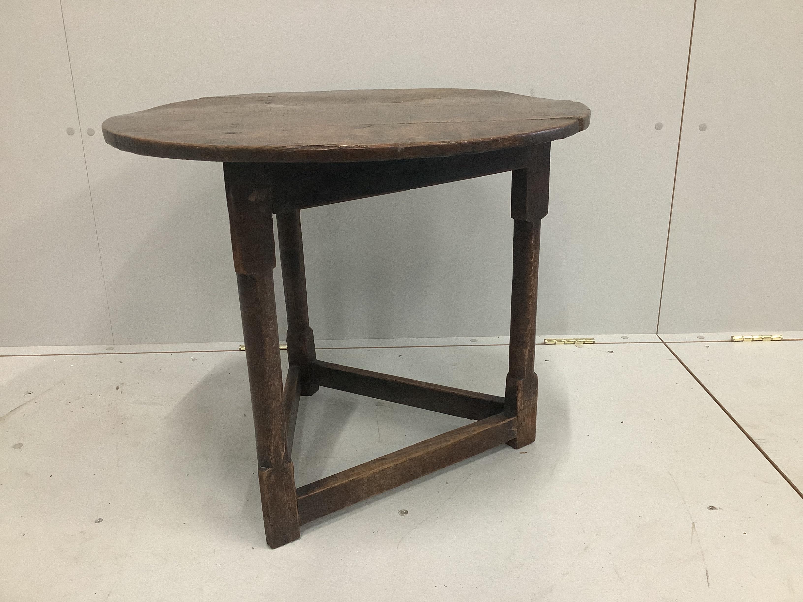 A late 18th century oak cricket table, diameter 64cm, height 55cm